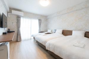 【デラックスツイン】28平米のバルコニー付きのお部屋。お部屋の中には洗濯機と乾燥機があり、長期滞在のお客様にもオススメです♪洗濯用洗剤は1回分50円でフロントにて販売中。