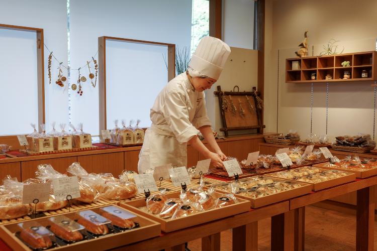 ベーカリーショップ「THE BAKERY」：館内の工房で作った自家製パンが並ぶベーカリー。季節限定のパンも登場します。(数量限定)
